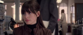 Movie still from “The Devil Wears Prada” (2006), directed by David Frankel – A person wearing a brown leather jacket; Close Up shot, Over the shoulder angle