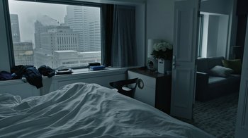 Movie still from “The Dissident” (2020), directed by Bryan Fogel – A bed room with a bed and a window with a view of a city; Wide shot, High angle