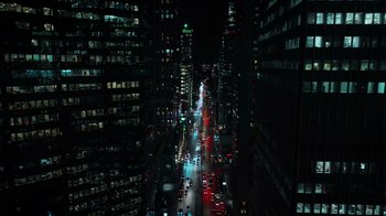 Movie still from “The Dissident” (2020), directed by Bryan Fogel – A view of a busy city at night with cars driving down the road; Extreme Wide shot, High angle