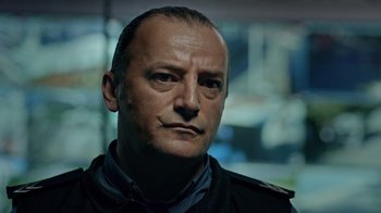 Movie still from “The Dissident” (2020), directed by Bryan Fogel – A person wearing a jacket; Close Up shot, Low angle