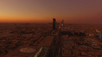 Movie still from “The Dissident” (2020), directed by Bryan Fogel – An aerial view of a city at night with the lights on; Extreme Wide shot, Overhead angle