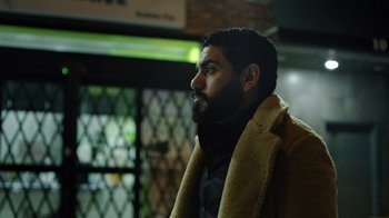 Movie still from “The Dissident” (2020), directed by Bryan Fogel – A man with a beard wearing a brown coat; Close Up shot, Low angle