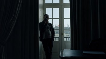 Movie still from “The Dissident” (2020), directed by Bryan Fogel – A man standing in front of an open door; Medium shot, Low angle