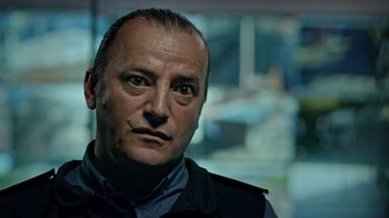 Movie still from “The Dissident” (2020), directed by Bryan Fogel – A person wearing a vest; Close Up shot, Low angle