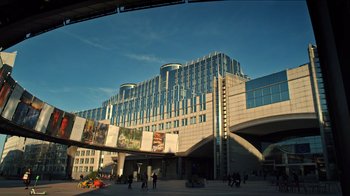 Movie still from “The Dissident” (2020), directed by Bryan Fogel – People are walking in front of a large building; Extreme Wide shot, High angle