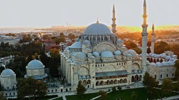 Movie still from “The Dissident” (2020), directed by Bryan Fogel – An aerial view of a large building with domes and spires; Extreme Wide shot, Low angle
