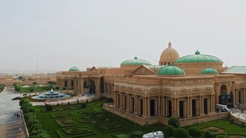 Movie still from “The Dissident” (2020), directed by Bryan Fogel – An aerial view of a large building with green domes; Extreme Wide shot, Low angle