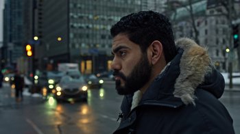 Movie still from “The Dissident” (2020), directed by Bryan Fogel – A person on a city street; Close Up shot, Low angle