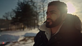 Movie still from “The Dissident” (2020), directed by Bryan Fogel – A man with a goatee is standing in the snow; Close Up shot, Low angle