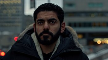 Movie still from “The Dissident” (2020), directed by Bryan Fogel – A person wearing a jacket; Close Up shot, Low angle