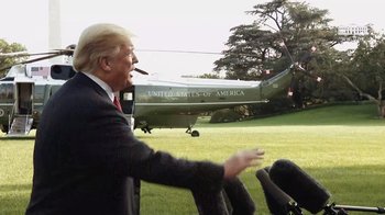 Movie still from “The Dissident” (2020), directed by Bryan Fogel – A man in a black suit smoking a cigarette in front of a helicopter; Wide shot, Over the shoulder angle