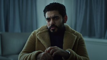 Movie still from “The Dissident” (2020), directed by Bryan Fogel – A person sitting in a room; Medium shot, Low angle