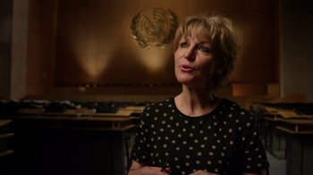 Movie still from “The Dissident” (2020), directed by Bryan Fogel – A woman in a black polka dot shirt is in a room; Close Up shot, Low angle