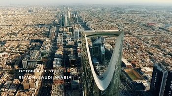 Movie still from “The Dissident” (2020), directed by Bryan Fogel – An aerial view of a large city with skyscrapers; Extreme Wide shot, Low angle