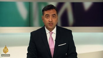 Movie still from “The Dissident” (2020), directed by Bryan Fogel – A man wearing a suit and tie in a room; Extreme Close Up shot, Low angle