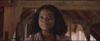 Movie still from “The Divergent Series: Insurgent” (2015), directed by Robert Schwentke – A person with long curly hair; Close Up shot, Low angle