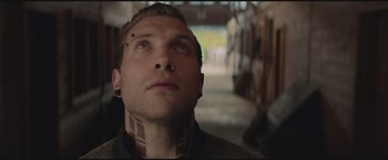 Movie still from “The Divergent Series: Insurgent” (2015), directed by Robert Schwentke – A person with tattoos on their face; Close Up shot, Low angle
