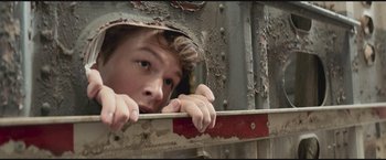 Movie still from “The Divergent Series: Insurgent” (2015), directed by Robert Schwentke – A young man looking out of a window; Close Up shot, Low angle