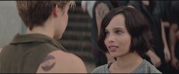 Movie still from “The Divergent Series: Insurgent” (2015), directed by Robert Schwentke – A woman with short black hair is talking to a man; Close Up shot, Over the shoulder angle