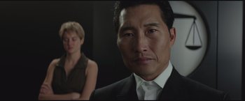 Movie still from “The Divergent Series: Insurgent” (2015), directed by Robert Schwentke – A person wearing a suit and tie; Close Up shot, Low angle