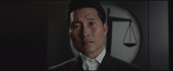 Movie still from “The Divergent Series: Insurgent” (2015), directed by Robert Schwentke – A person wearing a suit and tie; Close Up shot, Over the shoulder angle