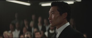 Movie still from “The Divergent Series: Insurgent” (2015), directed by Robert Schwentke – A person wearing a suit and tie; Close Up shot, Low angle