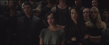 Movie still from “The Divergent Series: Insurgent” (2015), directed by Robert Schwentke – A group of people standing in front of each other in a room; Close Up shot, High angle