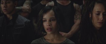 Movie still from “The Divergent Series: Insurgent” (2015), directed by Robert Schwentke – A young woman with short black hair is looking at the camera; Close Up shot, Over the shoulder angle