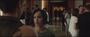 Movie still from “The Divergent Series: Insurgent” (2015), directed by Robert Schwentke – A woman with short brown hair standing in front of a group of people; Close Up shot, Over the shoulder angle