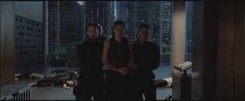 Movie still from “The Divergent Series: Insurgent” (2015), directed by Robert Schwentke – A group of men and women standing next to each other in a room; Wide shot, High angle