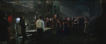 Movie still from “The Divergent Series: Insurgent” (2015), directed by Robert Schwentke – A group of people standing in front of a group of people; Wide shot, Over the shoulder angle