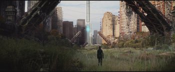 Movie still from “The Divergent Series: Insurgent” (2015), directed by Robert Schwentke – A man walking through a lush green grass field; Extreme Wide shot, High angle
