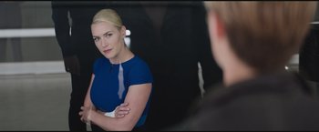 Movie still from “The Divergent Series: Insurgent” (2015), directed by Robert Schwentke – A woman in a blue dress looking into a mirror; Medium shot, Over the shoulder angle