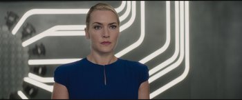 Movie still from “The Divergent Series: Insurgent” (2015), directed by Robert Schwentke – A woman in a blue dress standing in front of neon lights; Close Up shot, Low angle