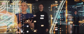 Movie still from “The Divergent Series: Insurgent” (2015), directed by Robert Schwentke – A man and a woman standing next to each other in front of a city skyline; Medium shot, Low angle