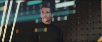 Movie still from “The Divergent Series: Insurgent” (2015), directed by Robert Schwentke – A man in a black shirt is looking at the camera; Close Up shot, Low angle