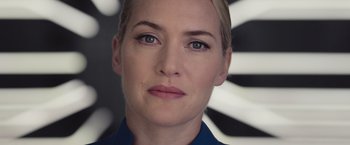 Movie still from “The Divergent Series: Insurgent” (2015), directed by Robert Schwentke – A woman's face in front of a black and white background; Close Up shot, Low angle