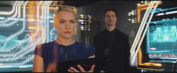 Movie still from “The Divergent Series: Insurgent” (2015), directed by Robert Schwentke – A man and a woman are looking at a tablet; Medium shot, Low angle