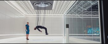 Movie still from “The Divergent Series: Insurgent” (2015), directed by Robert Schwentke – A man hanging upside down in a room; Wide shot, Overhead angle