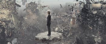 Movie still from “The Divergent Series: Insurgent” (2015), directed by Robert Schwentke – A man standing on top of a rock in the middle of a pile of rubble; Extreme Wide shot, High angle