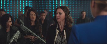 Movie still from “The Divergent Series: Insurgent” (2015), directed by Robert Schwentke – A group of people standing in front of a wall; Medium shot, Over the shoulder angle