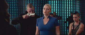 Movie still from “The Divergent Series: Insurgent” (2015), directed by Robert Schwentke – A woman in a blue dress and a man in a black shirt; Medium shot, Over the shoulder angle