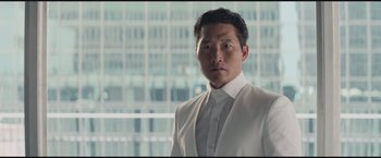 Movie still from “The Divergent Series: Insurgent” (2015), directed by Robert Schwentke – A person wearing a suit and tie; Close Up shot, Low angle