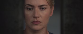 Movie still from “The Divergent Series: Insurgent” (2015), directed by Robert Schwentke – A woman's face in a dark room; Close Up shot, Over the shoulder angle