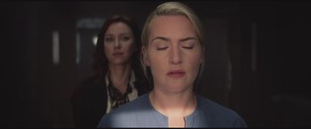 Movie still from “The Divergent Series: Insurgent” (2015), directed by Robert Schwentke – Two women are standing in the dark with their eyes closed; Close Up shot, Over the shoulder angle