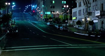Movie still from “The Driver” (1978), directed by Walter Hill – A city street at night lit by street lights; Extreme Wide shot, High angle