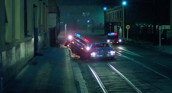 Movie still from “The Driver” (1978), directed by Walter Hill – A car that has fallen off the side of the road; Extreme Wide shot, High angle