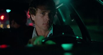 Movie still from “The Driver” (1978), directed by Walter Hill – A man sitting in the drivers seat of a car at night; Close Up shot, Low angle