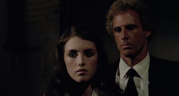 Movie still from “The Driver” (1978), directed by Walter Hill – A man and a woman standing next to each other; Close Up shot, Low angle