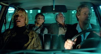 Movie still from “The Driver” (1978), directed by Walter Hill – A group of people sitting in the back of a car; Medium shot, Low angle